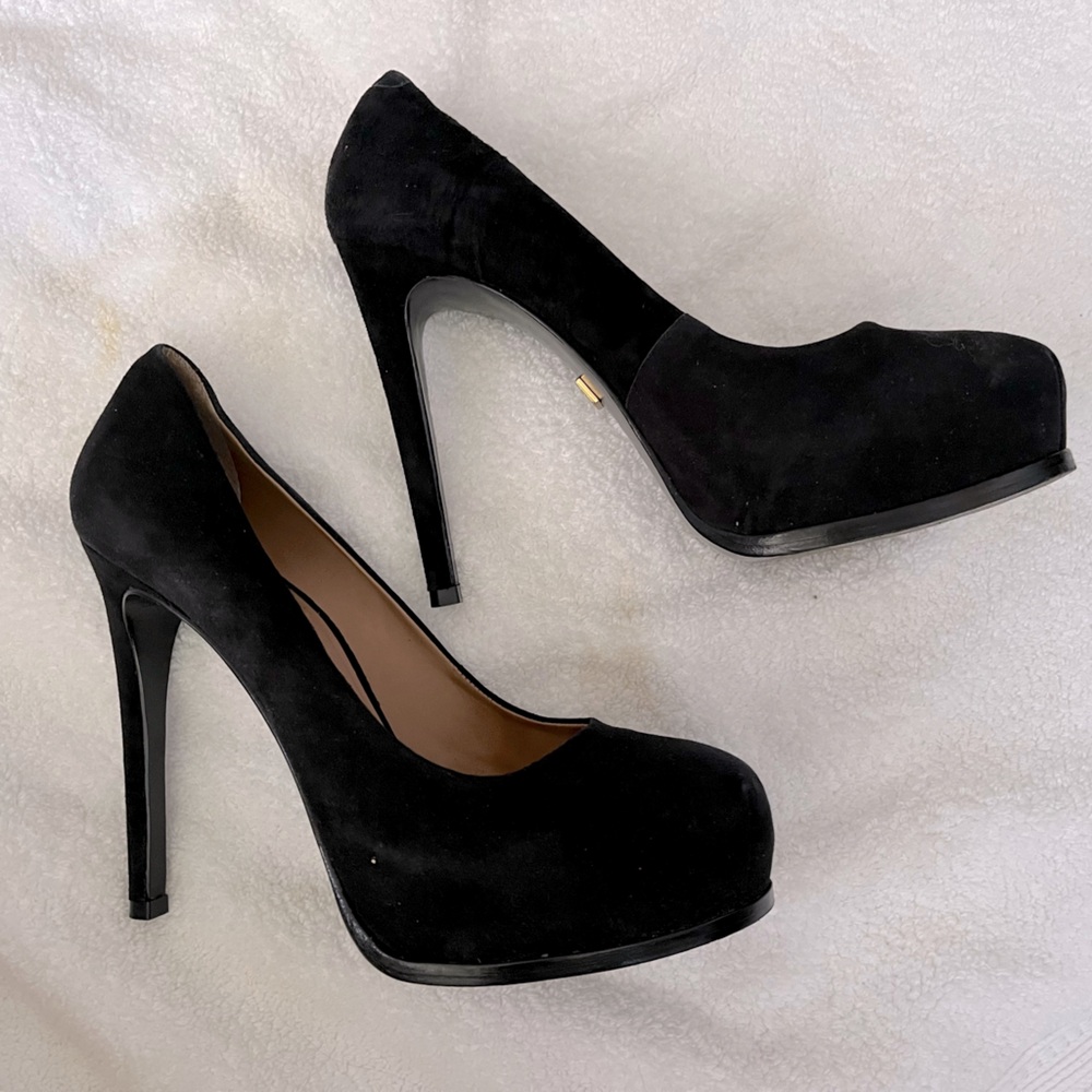 Woman’s platform black suade heel.